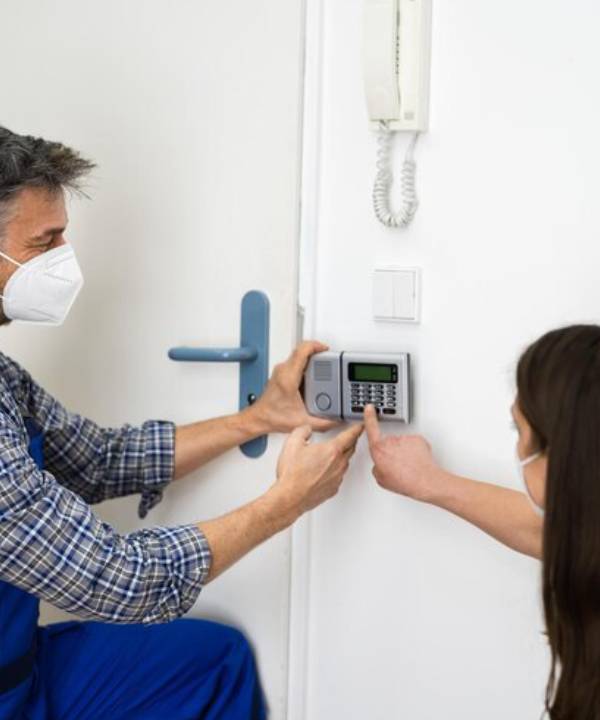 Security Alarm Installation Perth technician setting up home keypad